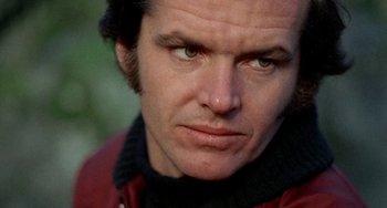 Movie still from “Five Easy Pieces” (1970), directed by Bob Rafelson – A man's face in a red jacket; Close Up shot, Low angle