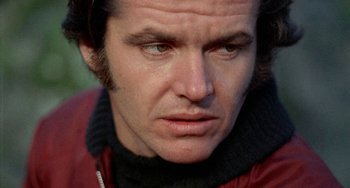 Movie still from “Five Easy Pieces” (1970), directed by Bob Rafelson – A man's face in a red jacket; Close Up shot, Low angle