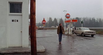 Movie still from “Five Easy Pieces” (1970), directed by Bob Rafelson – A man walking down the street near a gas station; Wide shot, Low angle