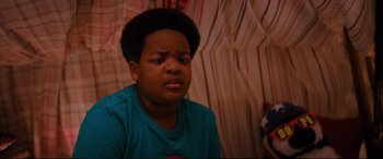 Movie still from “Good Boys” (2019), directed by Gene Stupnitsky – A young boy is sitting in front of a curtain; Close Up shot, High angle