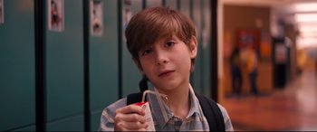 Movie still from “Good Boys” (2019), directed by Gene Stupnitsky – A young boy holding an object in his hand; Close Up shot, High angle