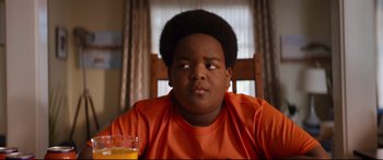 Movie still from “Good Boys” (2019), directed by Gene Stupnitsky – A young boy sitting at a dining room table with an orange juice in front of him; Close Up shot, Over the shoulder angle