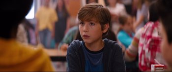 Movie still from “Good Boys” (2019), directed by Gene Stupnitsky – A young boy is sitting in front of a group of people; Close Up shot, Over the shoulder angle