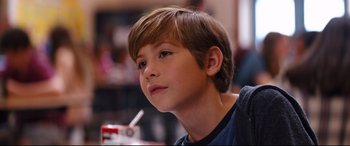Movie still from “Good Boys” (2019), directed by Gene Stupnitsky – A young boy is sitting at a table; Close Up shot, Over the shoulder angle