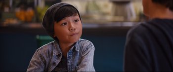 Movie still from “Good Boys” (2019), directed by Gene Stupnitsky – A young boy wearing a jean jacket and a hat; Close Up shot, Over the shoulder angle