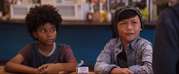 Movie still from “Good Boys” (2019), directed by Gene Stupnitsky – Two young people sitting at a table with a carton of milk; Close Up shot, Over the shoulder angle