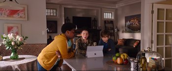 Movie still from “Good Boys” (2019), directed by Gene Stupnitsky – Three children sit at a table looking at a tablet; Medium shot, High angle