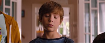Movie still from “Good Boys” (2019), directed by Gene Stupnitsky – A young boy with his eyes closed and his head turned to the side; Close Up shot, High angle