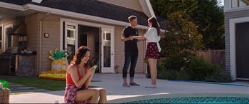 Movie still from “Good Boys” (2019), directed by Gene Stupnitsky – A man and a woman shake hands in front of a house; Wide shot, Over the shoulder angle
