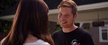 Movie still from “Good Boys” (2019), directed by Gene Stupnitsky – A young man smiling at a woman in front of a building; Close Up shot, Over the shoulder angle