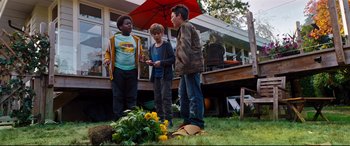 Movie still from “Good Boys” (2019), directed by Gene Stupnitsky – A group of young people standing in a yard; Wide shot, High angle