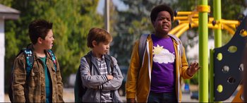 Movie still from “Good Boys” (2019), directed by Gene Stupnitsky – Two young boys standing next to each other on the street; Medium shot, Over the shoulder angle