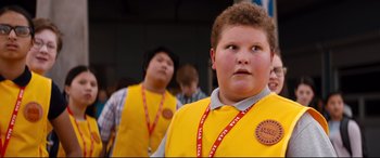 Movie still from “Good Boys” (2019), directed by Gene Stupnitsky – A boy wearing a yellow shirt and a red lanyard; Close Up shot, Low angle