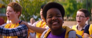 Movie still from “Good Boys” (2019), directed by Gene Stupnitsky – A child smiling at the camera; Close Up shot, Over the shoulder angle