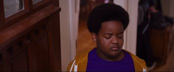Movie still from “Good Boys” (2019), directed by Gene Stupnitsky – A young boy with a purple shirt and a yellow jacket; Close Up shot, High angle