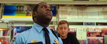 Movie still from “Good Boys” (2019), directed by Gene Stupnitsky – A police officer looking up at something in the air; Close Up shot, Over the shoulder angle