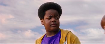Movie still from “Good Boys” (2019), directed by Gene Stupnitsky – A young boy with a yellow jacket and a purple shirt; Close Up shot, Low angle