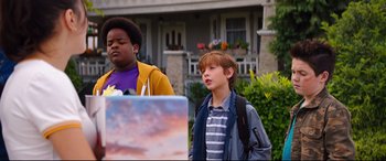 Movie still from “Good Boys” (2019), directed by Gene Stupnitsky – Two boys standing in front of a painting outside; Medium shot, Low angle