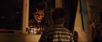Movie still from “Good Boys” (2019), directed by Gene Stupnitsky – A person wearing a demon mask in front of a mirror; Medium shot, Over the shoulder angle