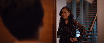 Movie still from “Good Boys” (2019), directed by Gene Stupnitsky – A woman standing in front of a wooden door; Medium shot, Over the shoulder angle