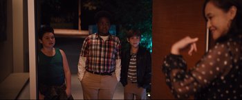 Movie still from “Good Boys” (2019), directed by Gene Stupnitsky – Two young men standing next to each other in front of a building; Medium shot, Over the shoulder angle