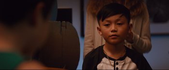 Movie still from “Good Boys” (2019), directed by Gene Stupnitsky – A young boy wearing a chain around his neck; Close Up shot, High angle