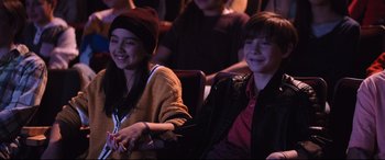 Movie still from “Good Boys” (2019), directed by Gene Stupnitsky – Two young people sitting in front of an audience; Medium shot, High angle