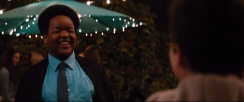 Movie still from “Good Boys” (2019), directed by Gene Stupnitsky – A woman standing in front of a bunch of lights; Medium shot, Over the shoulder angle