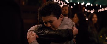 Movie still from “Good Boys” (2019), directed by Gene Stupnitsky – A young boy is hugging a woman in a crowd; Close Up shot, Over the shoulder angle