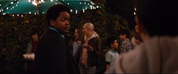 Movie still from “Good Boys” (2019), directed by Gene Stupnitsky – A group of young people standing in front of a tree; Medium shot, Over the shoulder angle