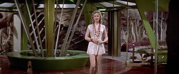 Movie still from “Forbidden Planet” (1956), directed by Fred M. Wilcox – A woman in a white dress standing in front of a fountain; Wide shot, Low angle