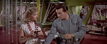 Movie still from “Forbidden Planet” (1956), directed by Fred M. Wilcox – A man and a woman sitting at a table in a restaurant; Medium shot, Over the shoulder angle
