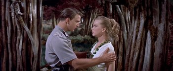 Movie still from “Forbidden Planet” (1956), directed by Fred M. Wilcox – A man and a woman are standing in front of each other; Medium shot, Low angle