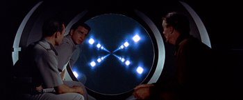 Movie still from “Forbidden Planet” (1956), directed by Fred M. Wilcox – Two men looking at each other in a mirror; Medium shot, Low angle