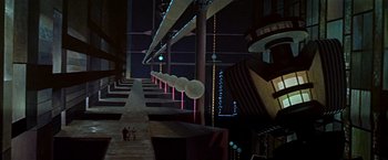 Movie still from “Forbidden Planet” (1956), directed by Fred M. Wilcox – A group of people standing next to each other in front of a building; Extreme Wide shot, Low angle