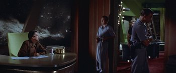 Movie still from “Forbidden Planet” (1956), directed by Fred M. Wilcox – A young boy standing in front of a television; Wide shot, Low angle