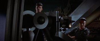 Movie still from “Forbidden Planet” (1956), directed by Fred M. Wilcox – A man standing in front of a large telescope; Medium shot, Low angle