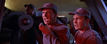 Movie still from “Forbidden Planet” (1956), directed by Fred M. Wilcox – A man and a woman are singing together; Medium shot, Low angle