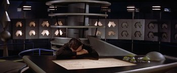 Movie still from “Forbidden Planet” (1956), directed by Fred M. Wilcox – A man sitting in front of a table with a map; Medium shot, High angle