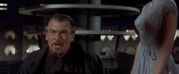 Movie still from “Forbidden Planet” (1956), directed by Fred M. Wilcox – An older man in a black shirt and black jacket; Close Up shot, Low angle