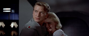Movie still from “Forbidden Planet” (1956), directed by Fred M. Wilcox – A man and a woman hugging each other in a room; Close Up shot, Low angle