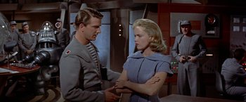 Movie still from “Forbidden Planet” (1956), directed by Fred M. Wilcox – A man and a woman are standing next to each other; Medium shot, Over the shoulder angle