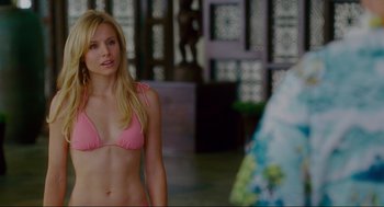 Movie still from “Forgetting Sarah Marshall” (2008), directed by Nicholas Stoller – A woman in a pink bikini standing in front of another woman; Medium shot, Over the shoulder angle