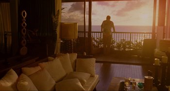 Movie still from “Forgetting Sarah Marshall” (2008), directed by Nicholas Stoller – A man standing on a balcony looking out at the ocean; Extreme Wide shot, Over the shoulder angle