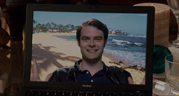Movie still from “Forgetting Sarah Marshall” (2008), directed by Nicholas Stoller – A man is smiling in front of a computer screen; Close Up shot, Over the shoulder angle