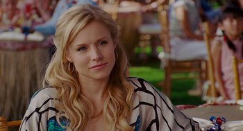 Movie still from “Forgetting Sarah Marshall” (2008), directed by Nicholas Stoller – A woman with long blonde hair wearing a black and white top; Close Up shot, Over the shoulder angle