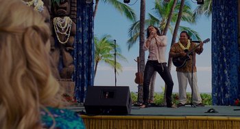 Movie still from “Forgetting Sarah Marshall” (2008), directed by Nicholas Stoller – A woman singing on stage with a microphone; Wide shot, Over the shoulder angle