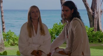 Movie still from “Forgetting Sarah Marshall” (2008), directed by Nicholas Stoller – A man and a woman sitting next to each other on the beach; Medium shot, Over the shoulder angle