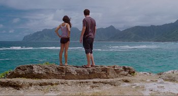 Movie still from “Forgetting Sarah Marshall” (2008), directed by Nicholas Stoller – A man and a woman standing on top of a cliff; Wide shot, Over the shoulder angle