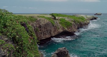 Movie still from “Forgetting Sarah Marshall” (2008), directed by Nicholas Stoller – A body of water that has some rocks on it; Extreme Wide shot, High angle